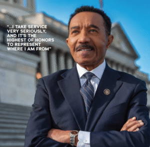 Congressman Kweisi Mfume stands on steps of US Capitol with arms folded. Image by P.A. Greene.
